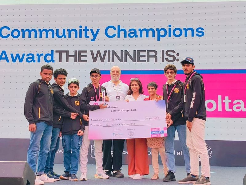 Team VoltEdge receiving the Community Champions Award trophy on stage at IIT Bombay.